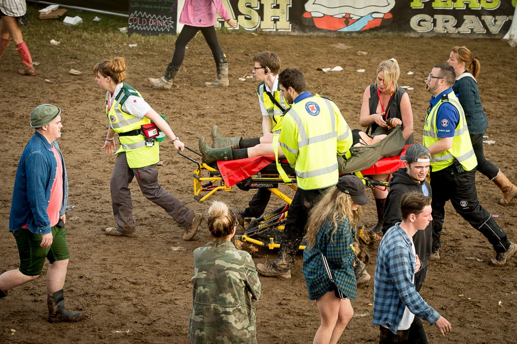 T in The Park, 2015, Day Three. T in The Park has it's first day on it's new site at Strathallan Castle. Thousands of festival goers brave the rain to attend the 22nd TiTP. IN PIC................. A female reveler is stretchered to the medical tent. (c) Wullie Marr/DEADLINE NEWS For pic details, contact Wullie Marr........... 07989359845