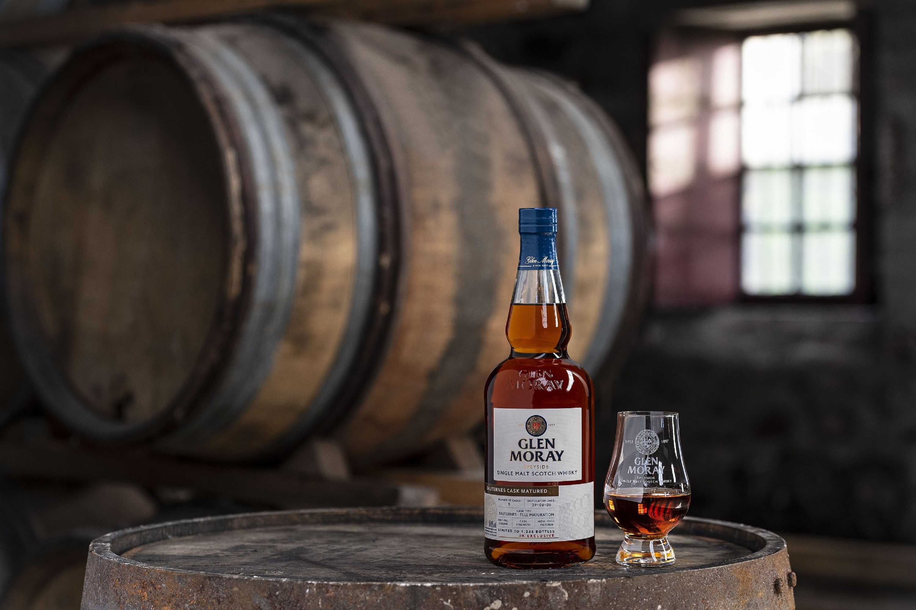 Glen Moray whisky bottle on barrel