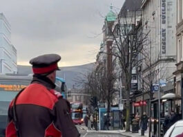 The parking warden watched on and did nothing as the car blocked the bus stop.