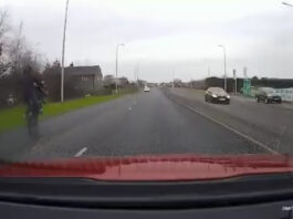 The teen flew along the road on one wheel.