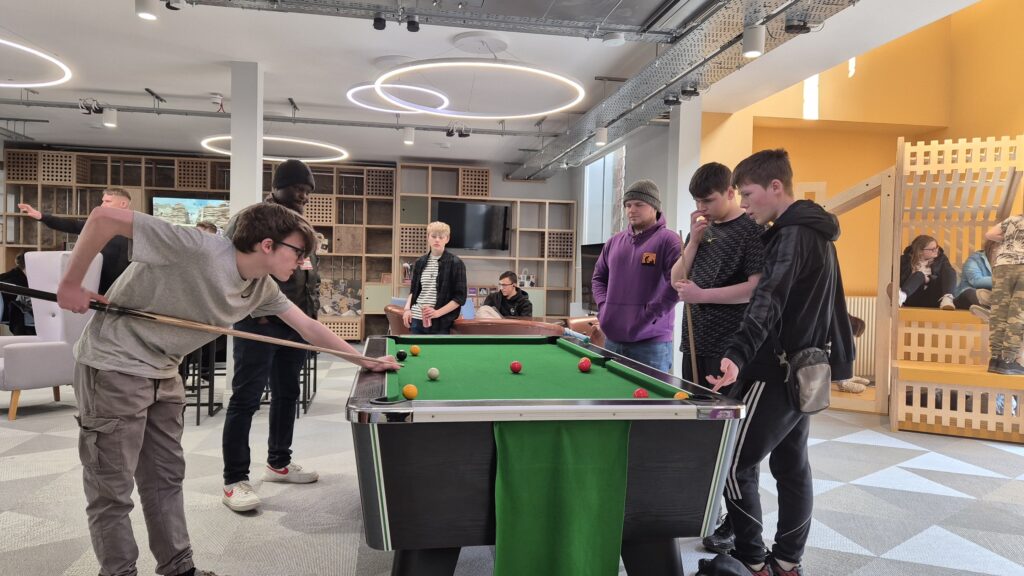 Group of youth playing pool at the Y Centre.