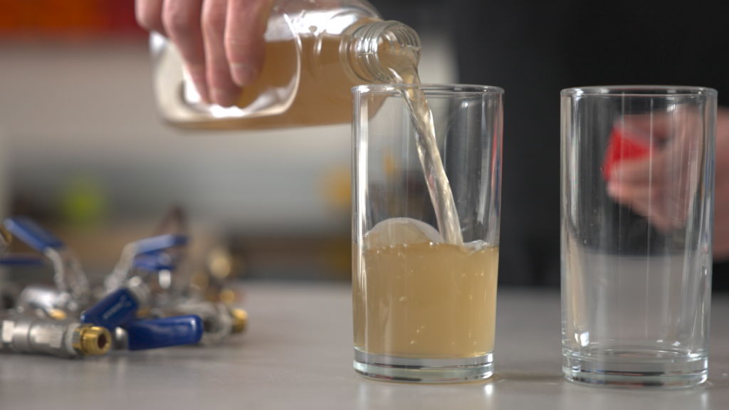 Brown water being poured into a glass. Image supplied with release by Hot Tin Roof