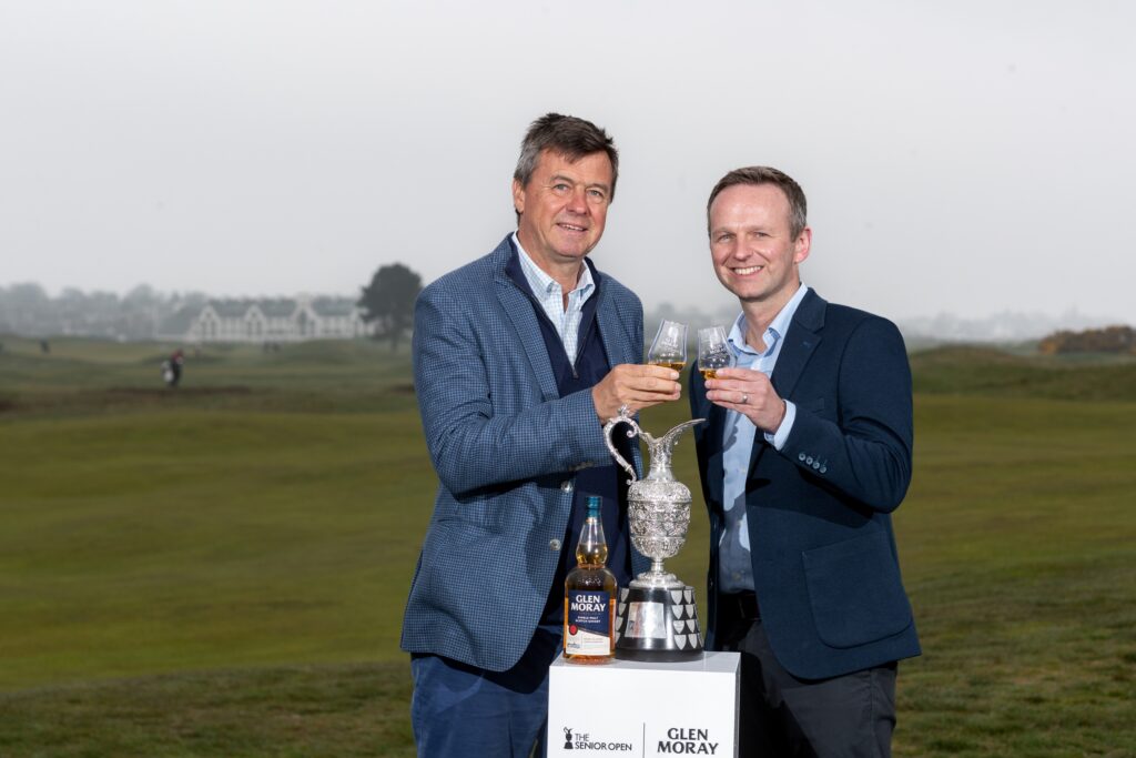 Edward Kitson, Championship Director, The Senior Open; Jamie Stewart, Commercial Director, LMB-UK stand with the trophy. Image supplied with release by Burt Greener.
