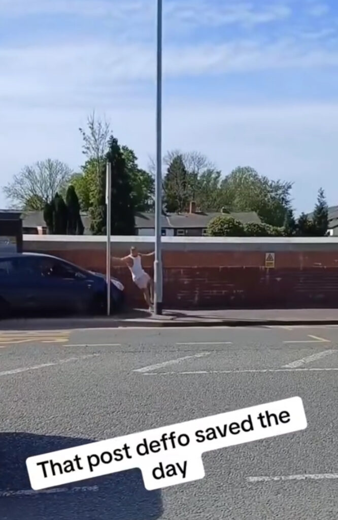 The man barely managed to avoid the car by jumping behind a lamppost.
