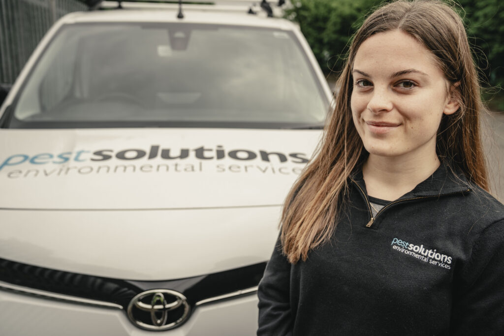 Masie Bullock stands next to a Pest Solutions van. Image supplied with release by Spreng Thomson