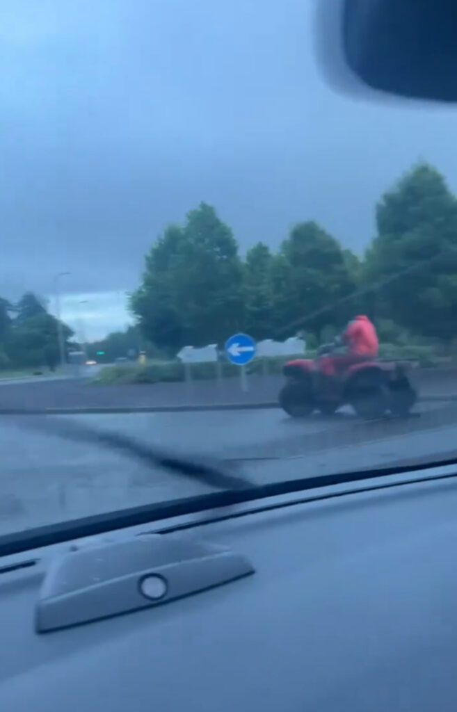 The bold driver drifted his quad bike almost completely round the roundabout.