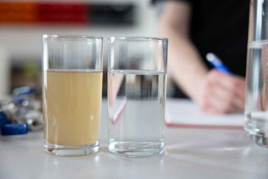 Unpurified vs purified water. One clear, one murky. Image supplied with release by Hot Tin Roof