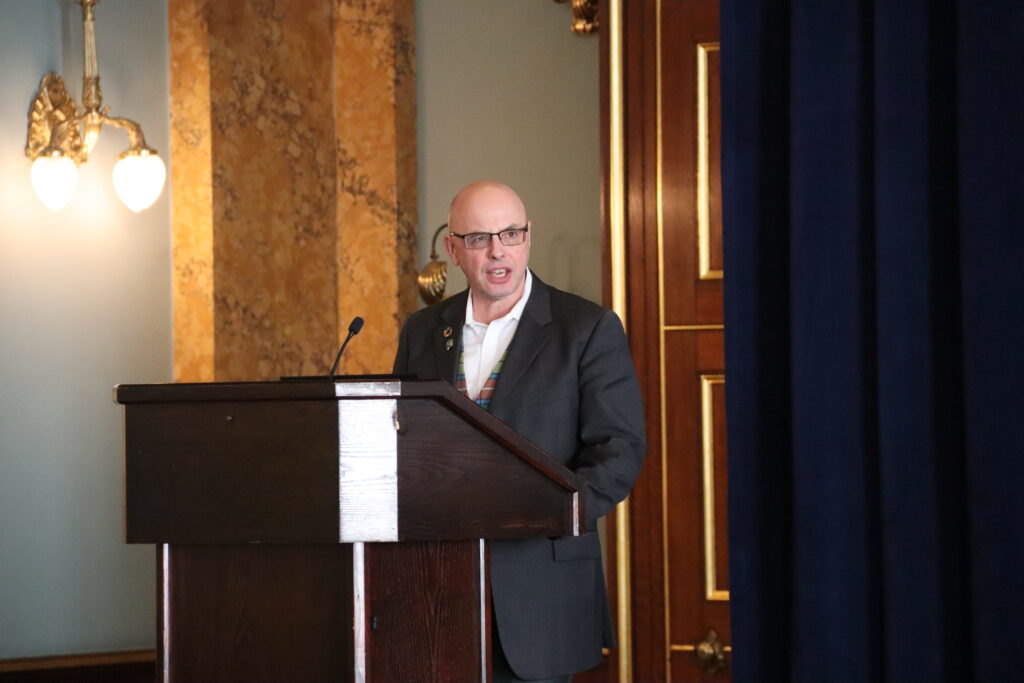 Stuart McLanaghan speaks at a podium.