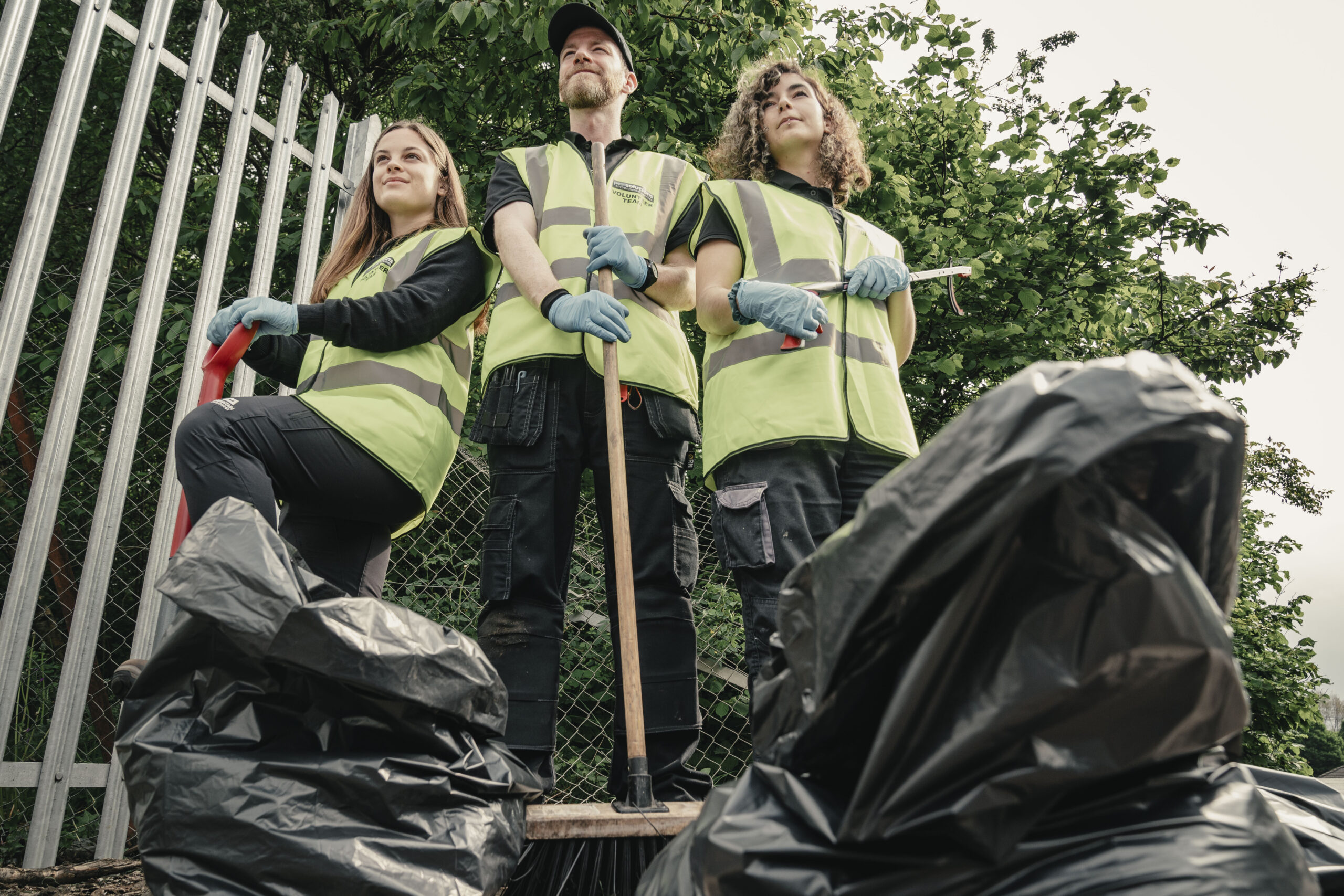 Volunteers standing with collected litter