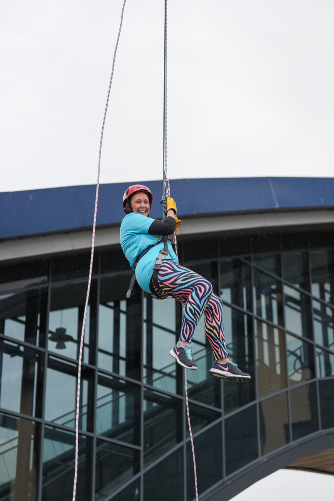 Volunteer abseils down the tower at last year's event. Image supplied with release by Big Partnerships 