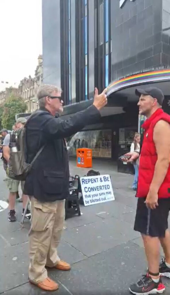 Reverend Jim Thornton preaching to a grieving father in the centre of Glasgow