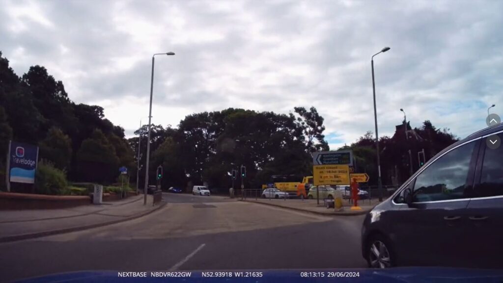 Dashcam footage from the car exiting a roundabout, as the grey Seat cuts across closely in front of it