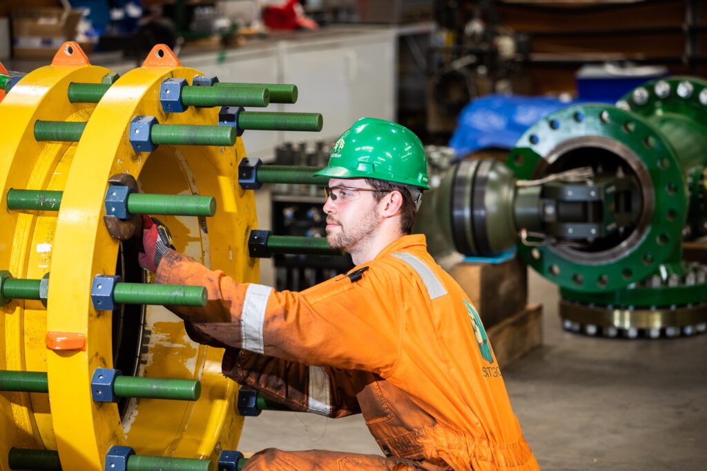 STATS Group employee working on machinery.