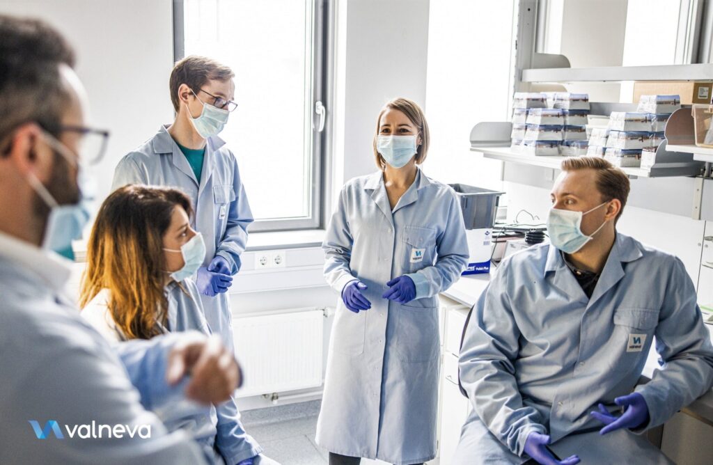 Valneva scientists discussing in a lab.