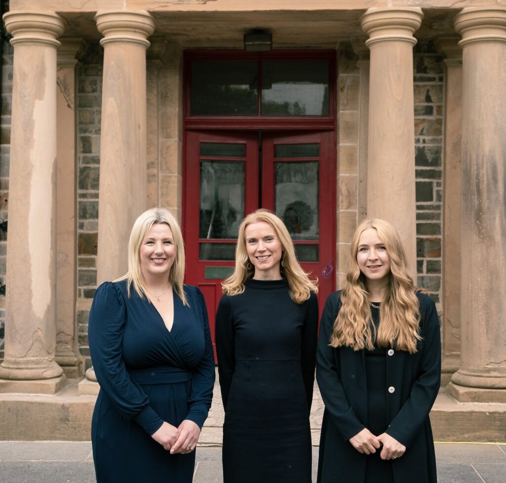 Ellen Euson (L), Shelia Tulloch (C) and Alice Tait (R) smile in front of their new office. Image supplied with release by Clark Communications.