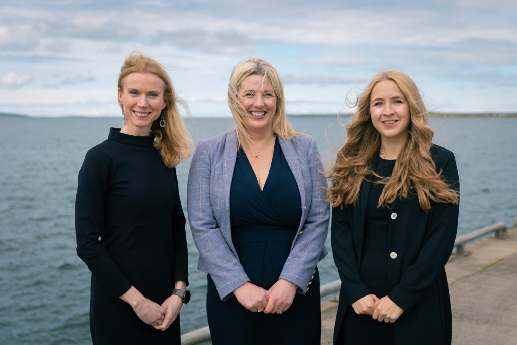 Shelia Tulloch (L), Ellen Euson (C) and Alice Tait (R) smile in Kirkwall. Image supplied with release by Clark Communications.