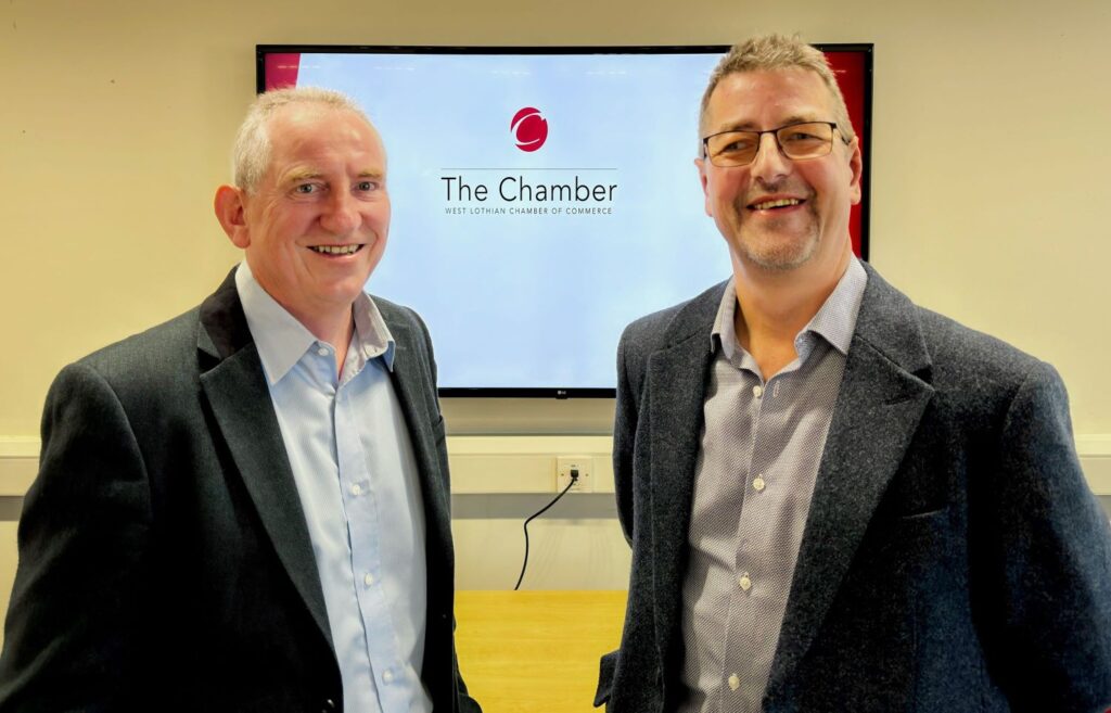 Jim Stewart and Paul Hunter smiling in the West Lothian Chamber of Commerce.