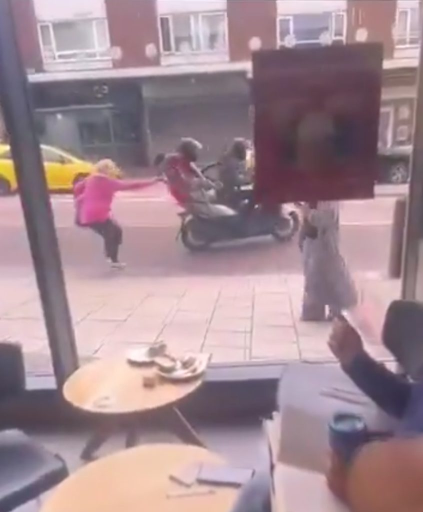 THIS is the moment a brave woman stops a pair of thieves from nicking her e-bike, grabbing it from the back of their moped and pulling one of the thieves off with it.