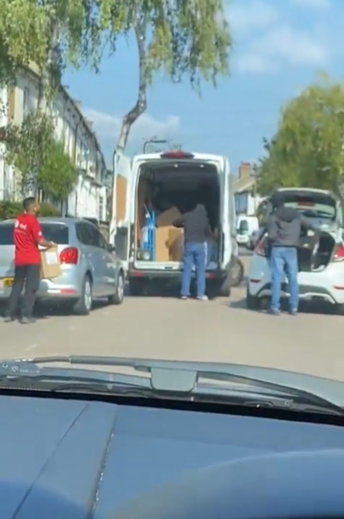 THIS is the shocking moment a helpless DPD driver can only watch on as he is robbed in broad daylight, with hooded thugs raiding his delivery van for parcels.