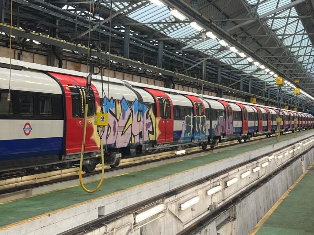 An image of a train partially covered with spray-painted graffiti.