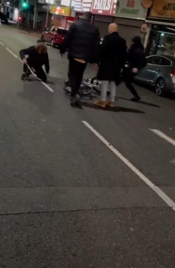 HARROWING footage shows the moment a machete-wielding cyclist is disarmed and assaulted by a large mob of pedestrians.