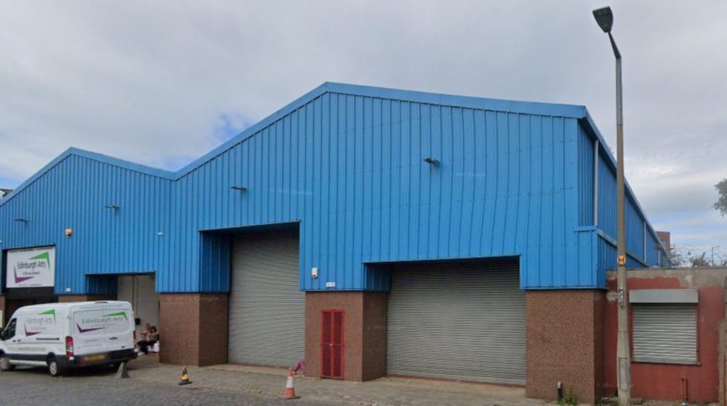 An image of a blue-fronted industrial building.