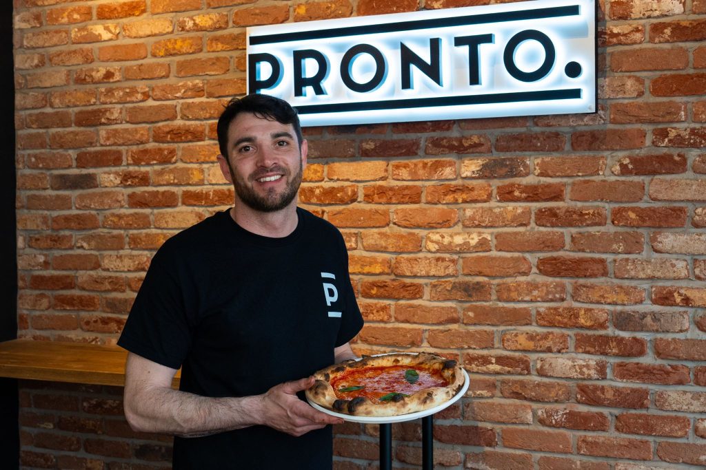 Michael infront of the Pronto sign