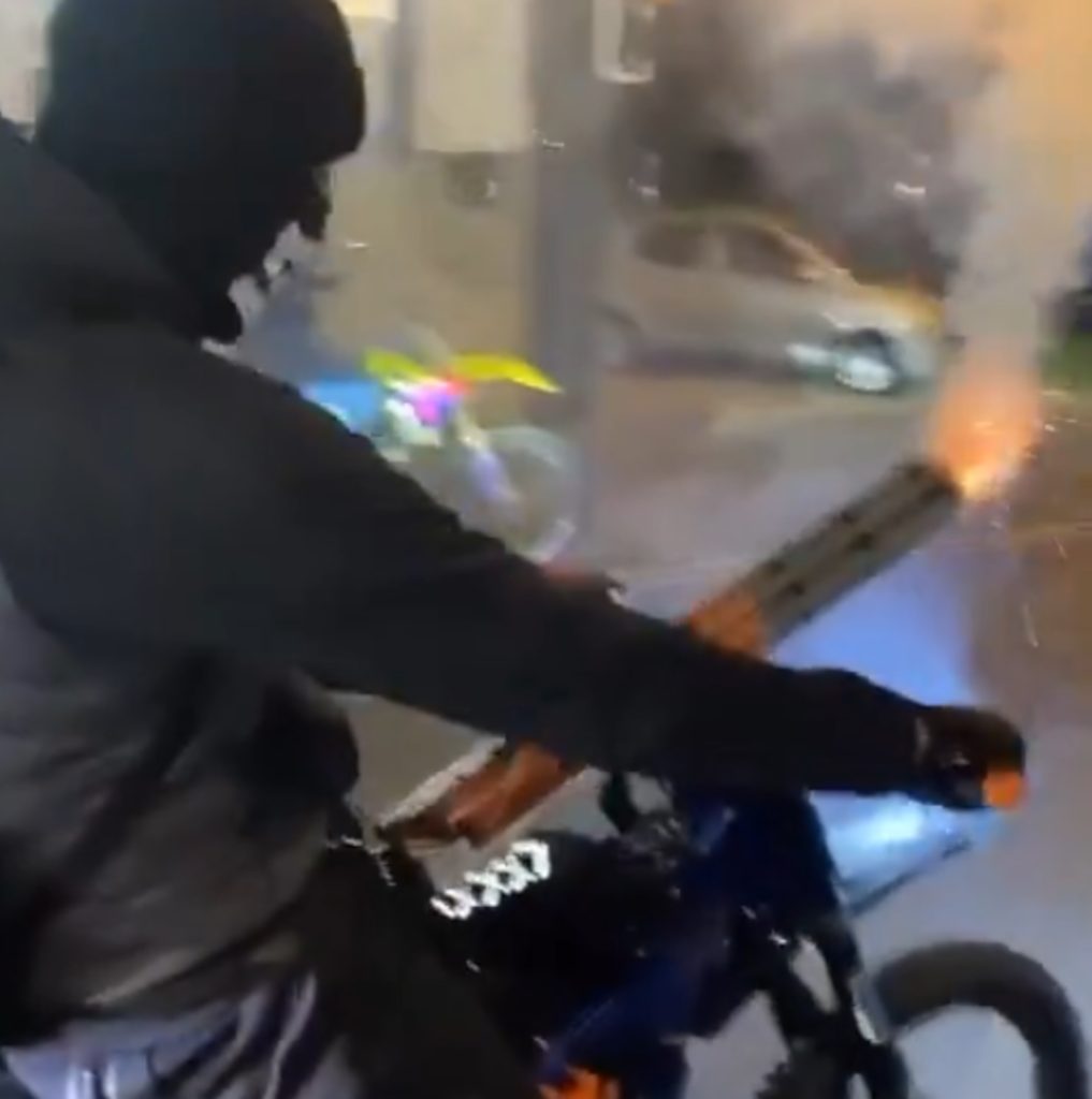 A GROUP of “pathetic” yobs strapped fireworks to a dirt bike before speeding down a city street launching barrages of rockets into the air.