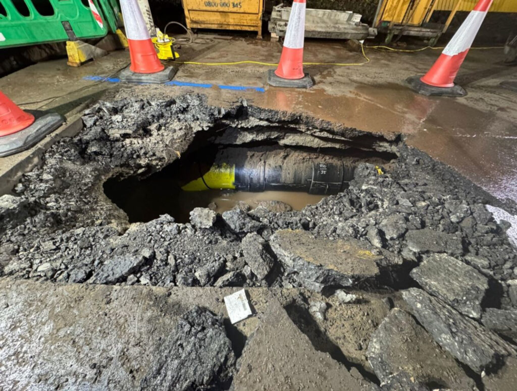 An image of an open roadworks excavation, surrounded by cones