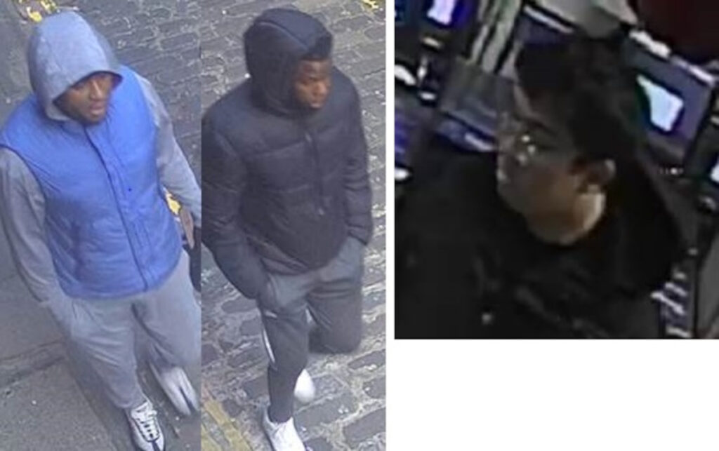 An image of the three men sought in connection with the assault and robbery - one man is black, wearing a blue gilet, the other man is black , wearing a black padded jacket and the third man is Asian, and wears glasses. All three are described as 6ft tall and of stocky build.