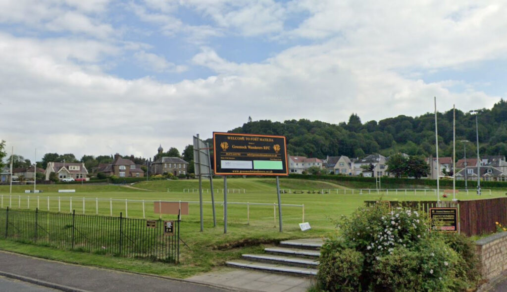 An image of a rugby pitch next to a road.