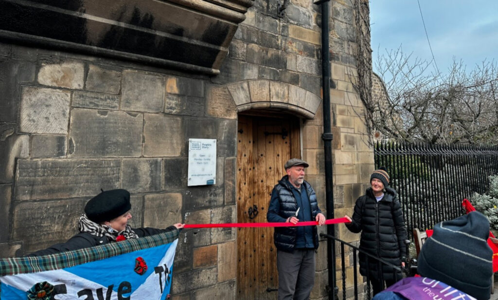 Save The People's Story Museum campaigner Jim Slaven cutting the ribbon to reopen the museum.