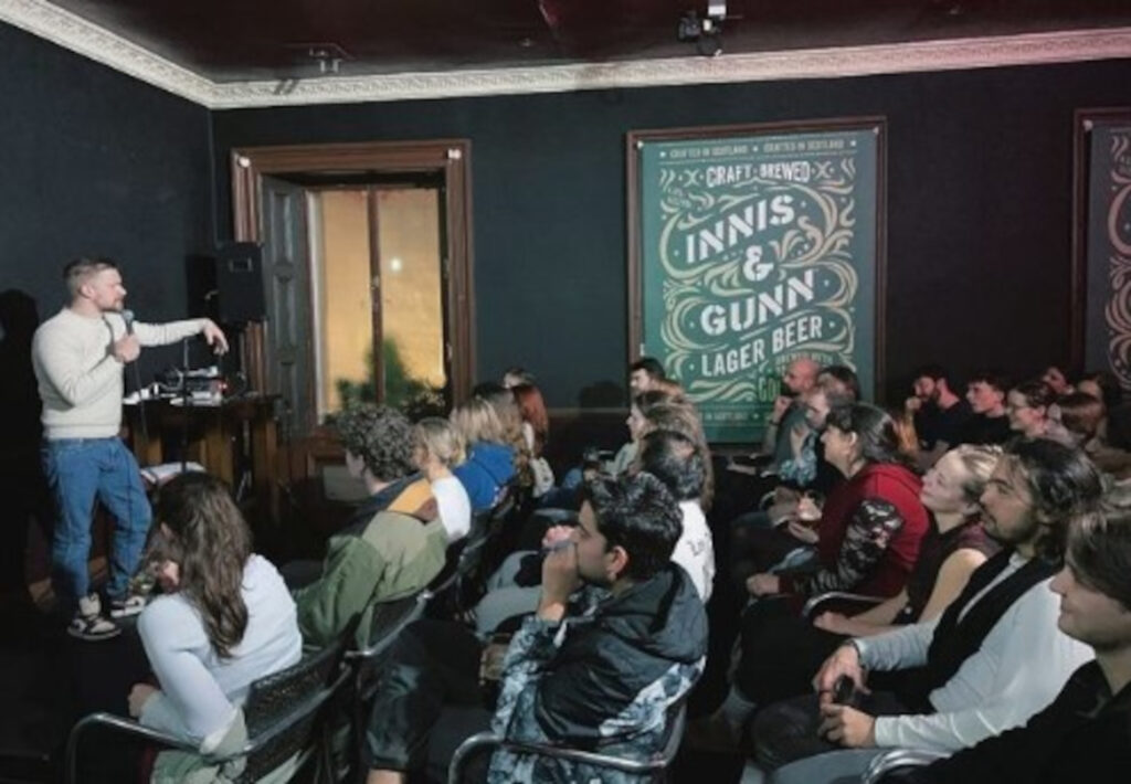 Sloss performing at Spandex, a comedy night above the Beehive Inn on Grassmarket. (C) Spandexcomedy/Instagram