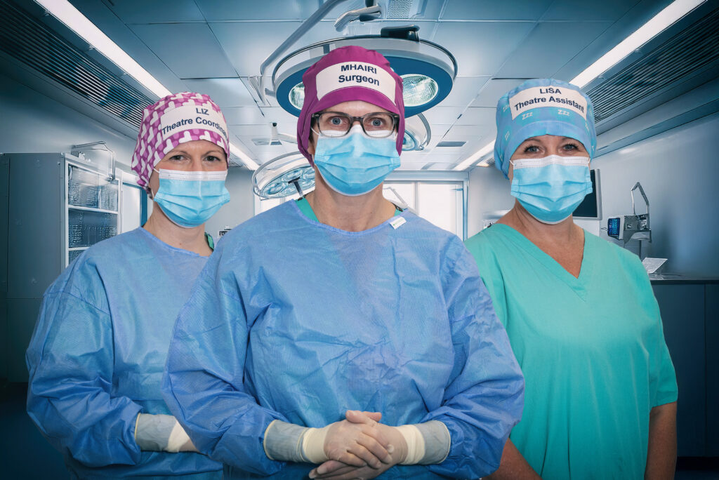 An image of three hospital staff wearing the new sustainable theatre caps in different colours.