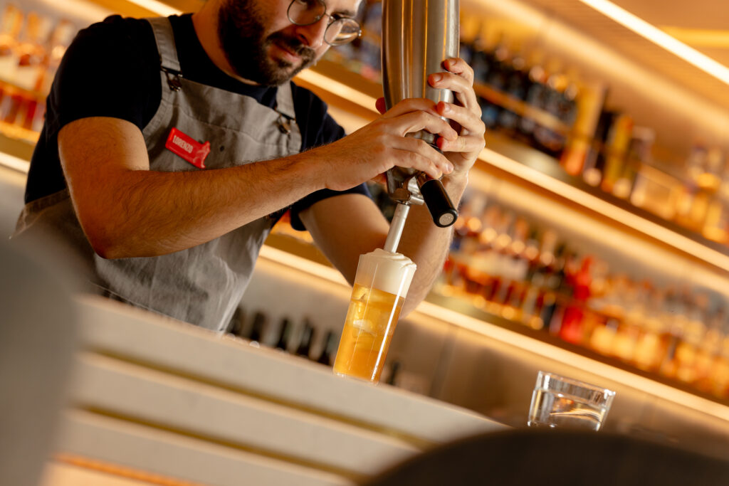 A bartender at Johnnie Walker Princes Street making an Iron Brew and vanilla ice cream cocktail.