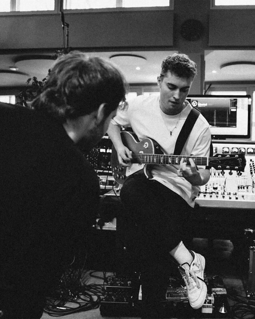 An image from Sam Fender's Facebook page of the singer playing guitar in the studio.