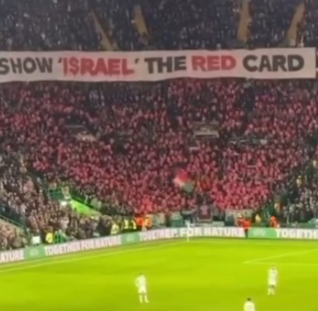 Celtic fans raising a sign that says "Show 'Israel' the red card" at their match against Bayern Munich last month (C) @green.brigade.ultras/Instagram